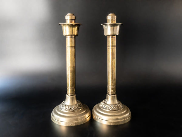 A pair of gold-plated and bronze church candle holders. …